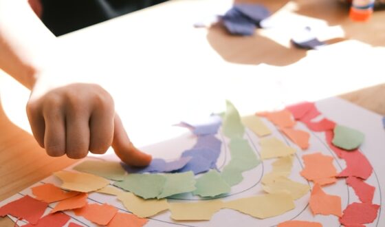 person holding pink and white heart print paper