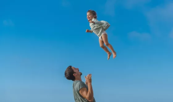 a man and a little girl flying through the air